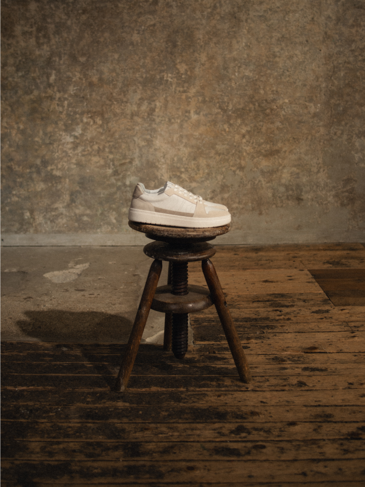 European men's Italian white leather sneakers with beige suede accents white laces and white rubber soles.