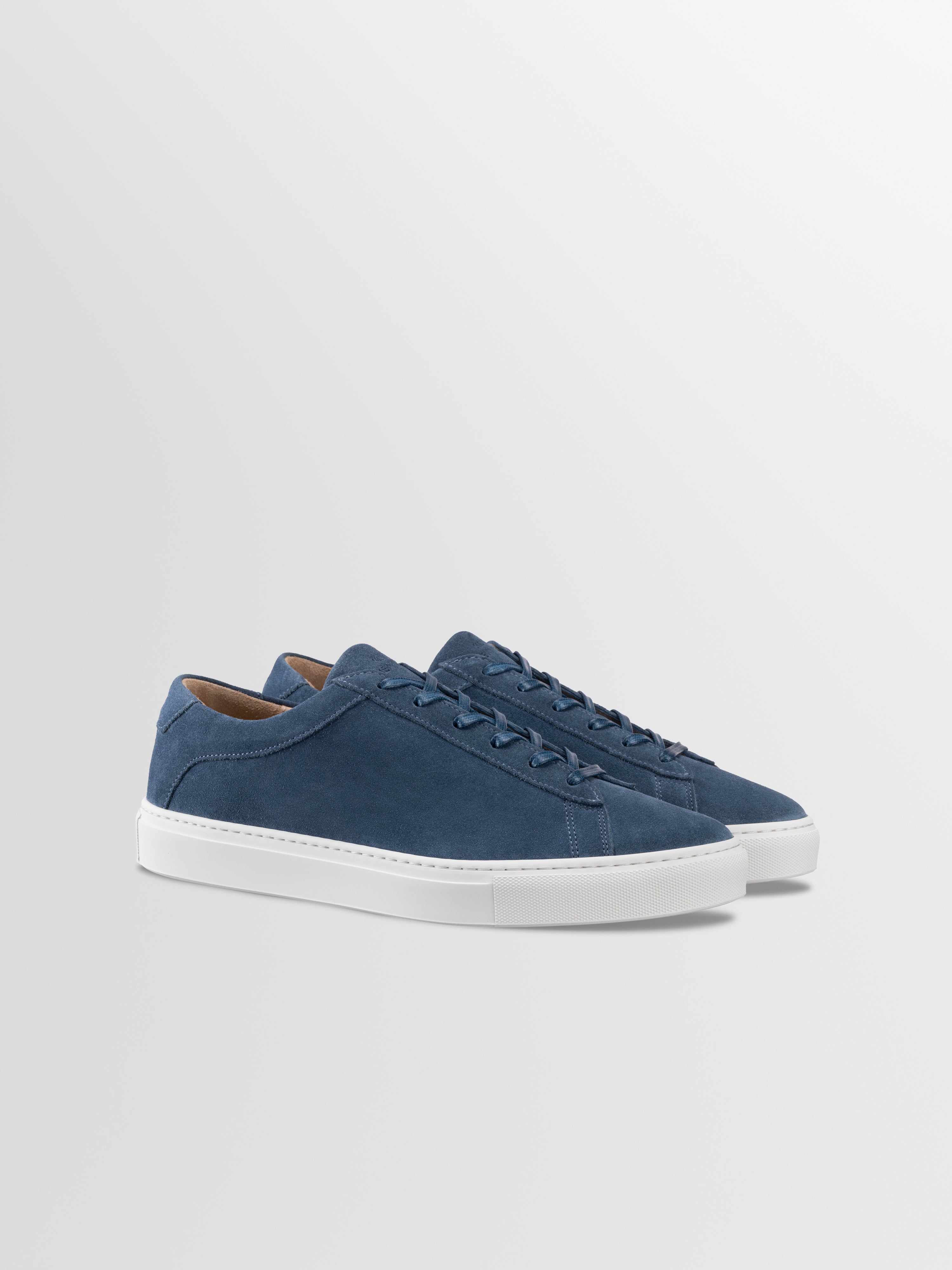 Blue suede sneakers with matching laces and white rubber soles
