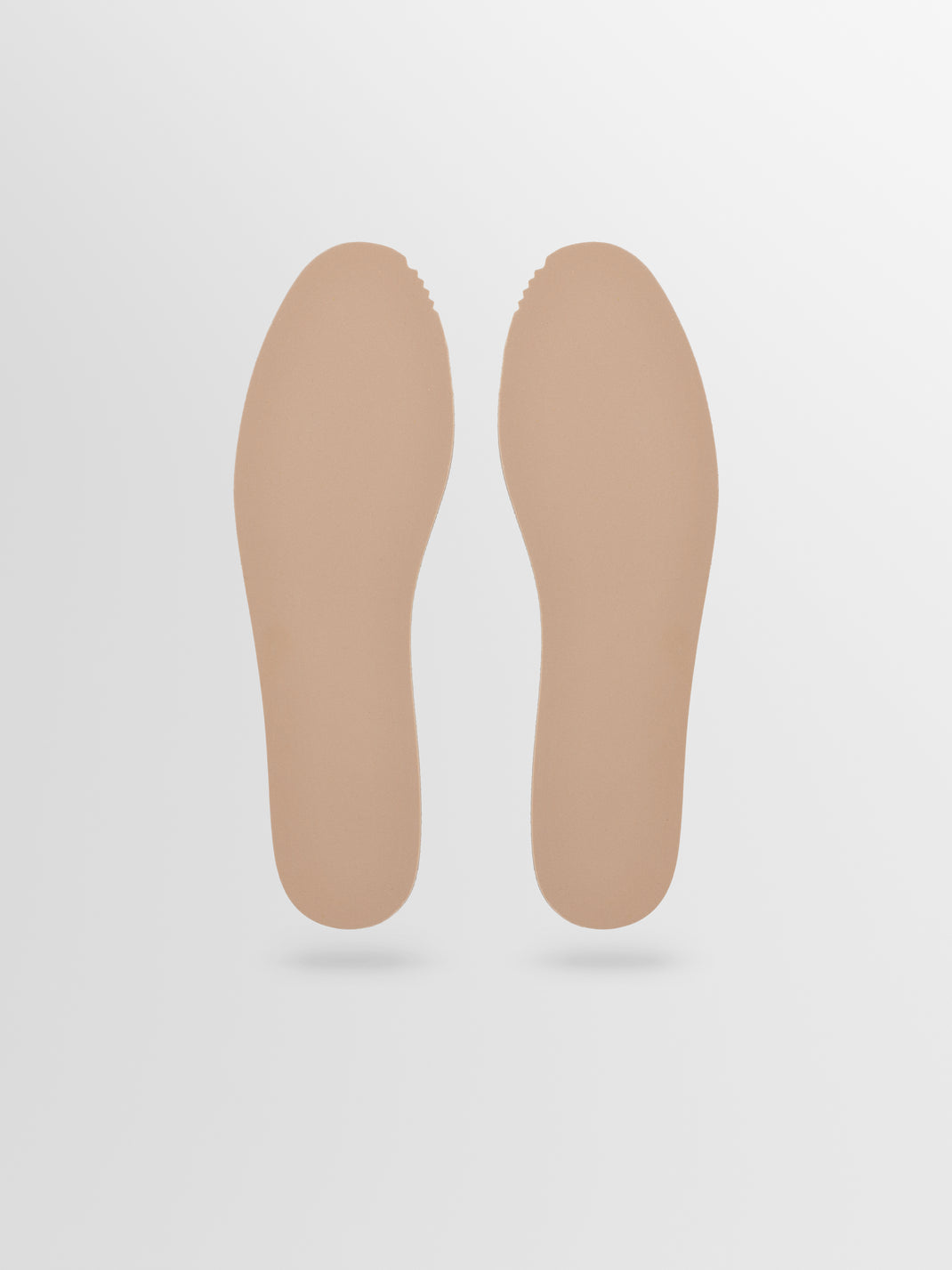 Top view of a pair of Garda insoles showcasing their beige color and contoured shape on a light gray background