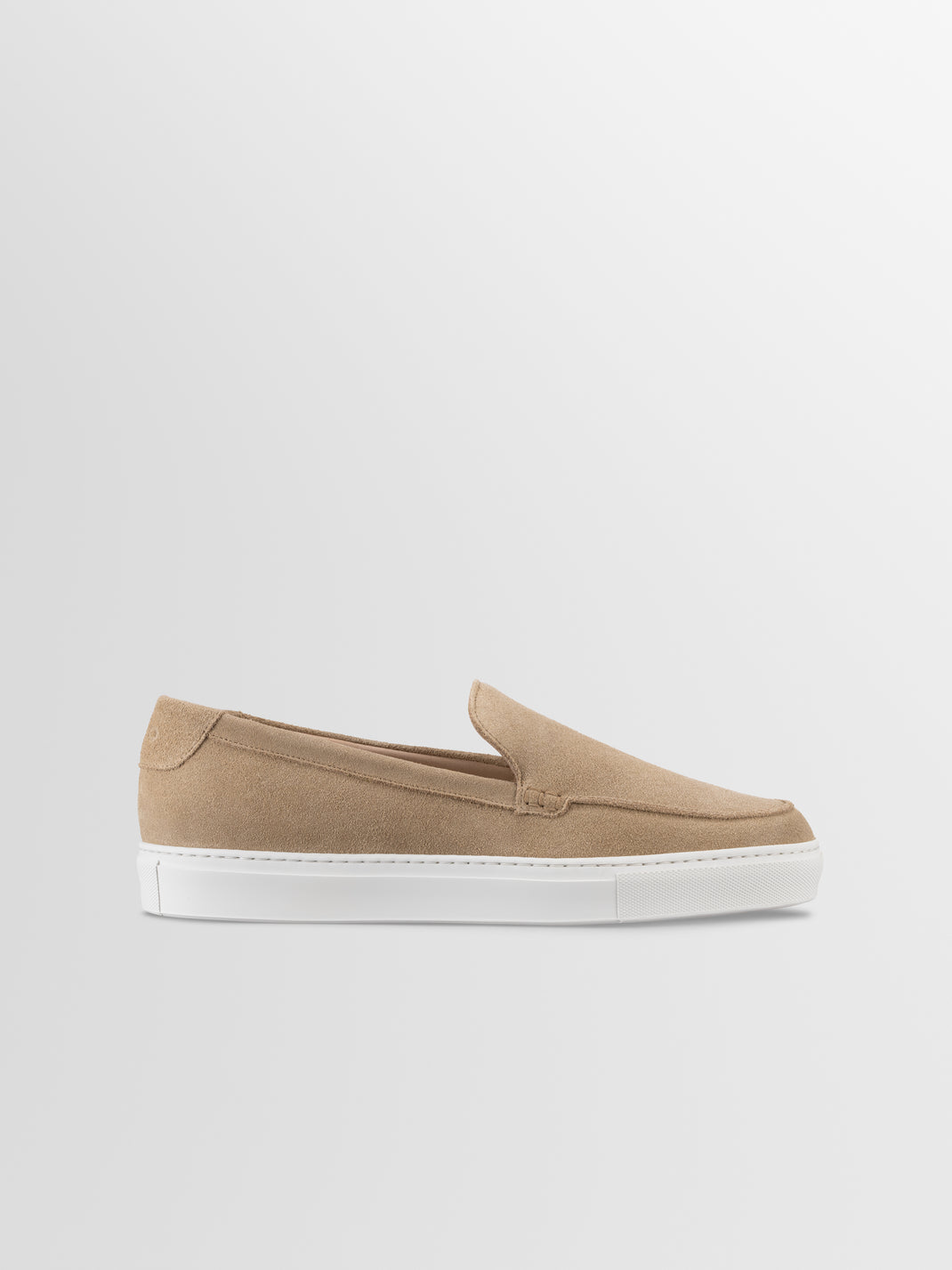 Side view of Lido in Fawn suede slip-on loafer showcasing its white rubber sole against a light gray background