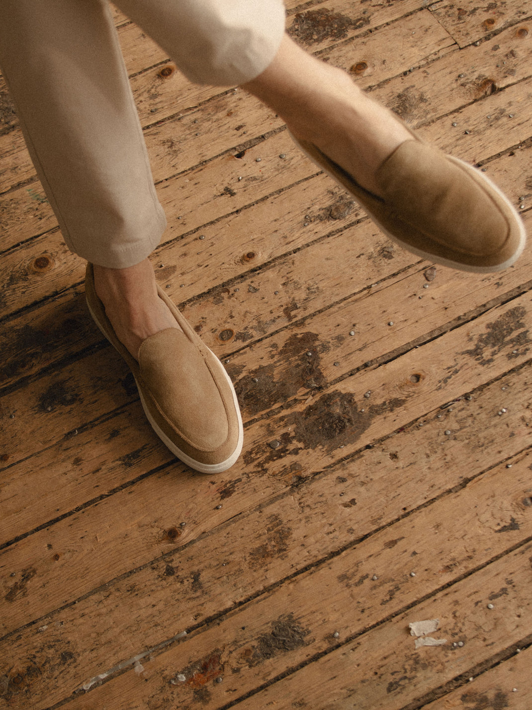 Top view of Lido in Fawn mens beige suede slip-on loafers showcasing rounded toes on a rustic wood floor