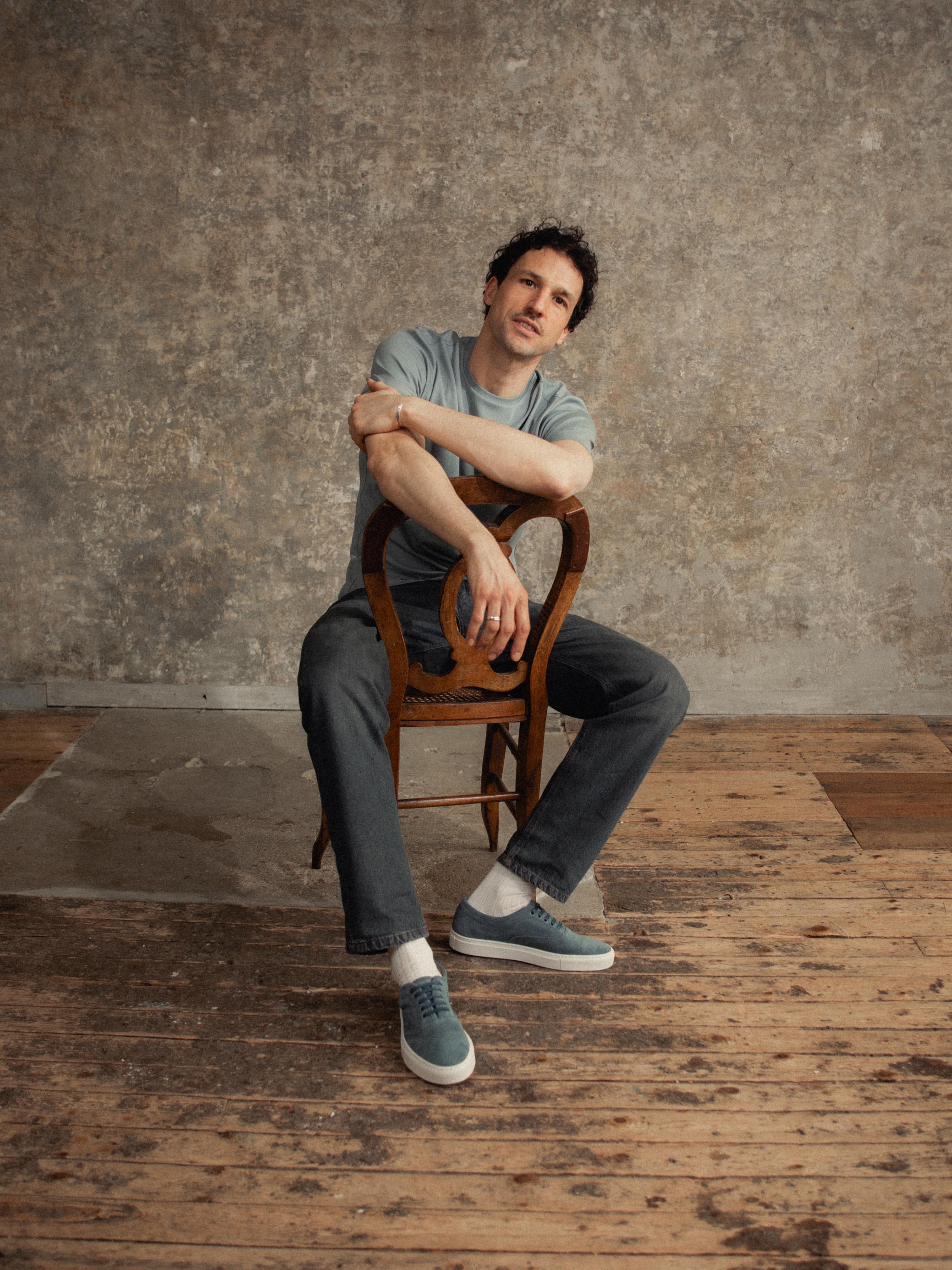 Man sitting on wooden chair wearing Men