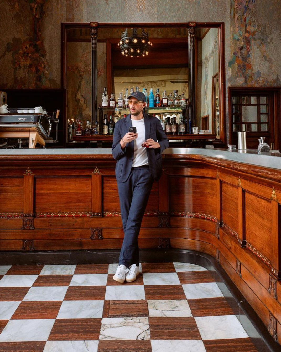 Caleb Thill wearing white Capri with gum sole low-top sneakers at a bar