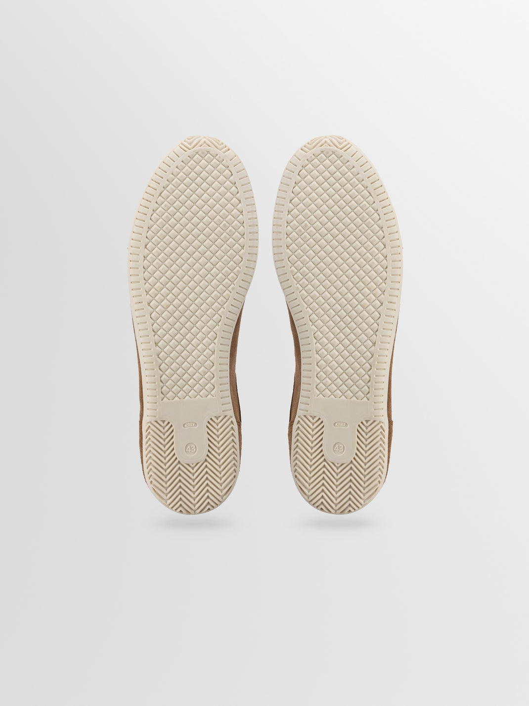 Bottom view of Parma suede sneaker in Cognac showing cream rubber soles, size 43 markings, and textured tread