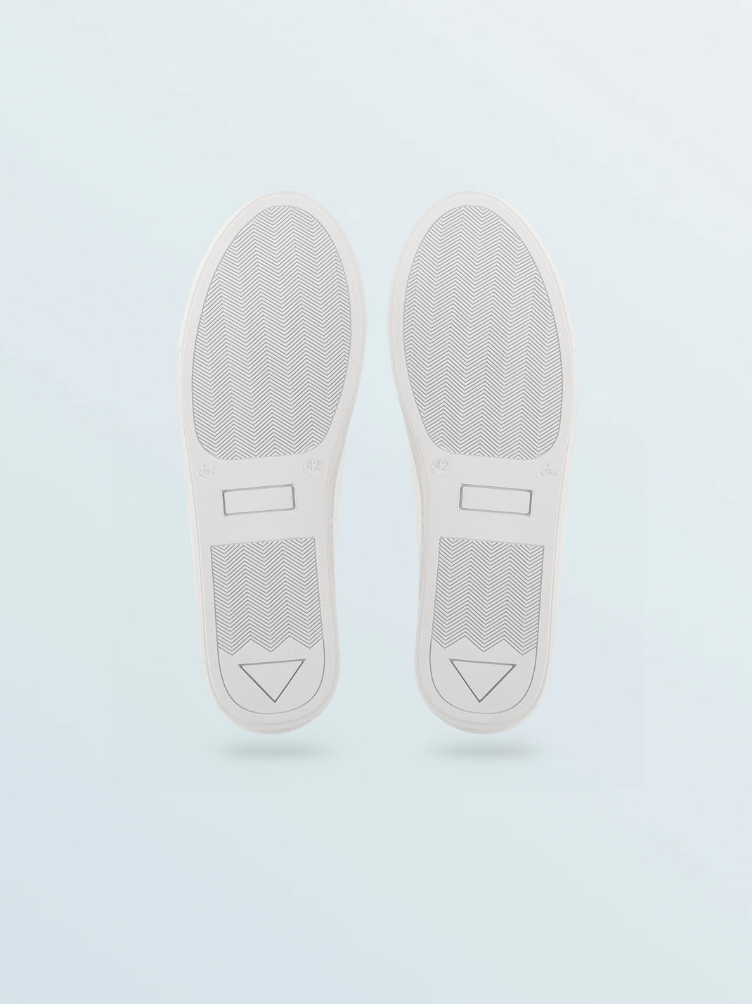 Bottom view of Vegan 01 Triple White sneakers showcasing chevron tread and size 42 markings against a pale blue background